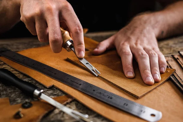 depositphotos_404972744-stock-photo-close-up-of-a-shoemaker.jpg